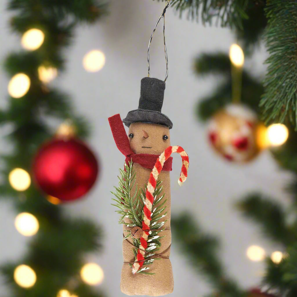 Stringed ornament with a snowman in a top hat and red scarf holding a candy cane