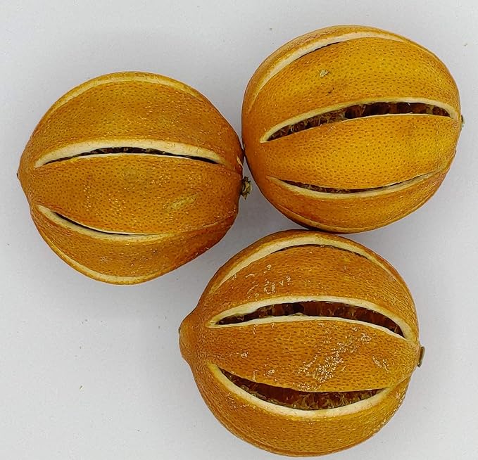 Three slit oranges with a visible segmented design on a white background.