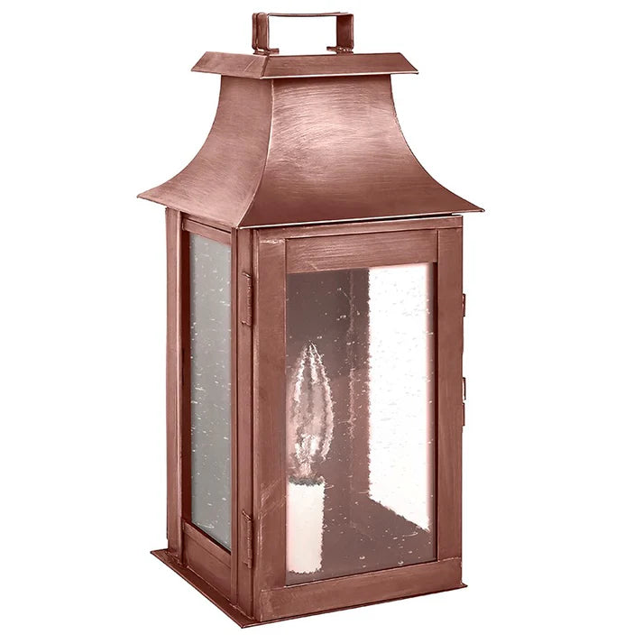 Copper lantern with a clear glass cover on a white background