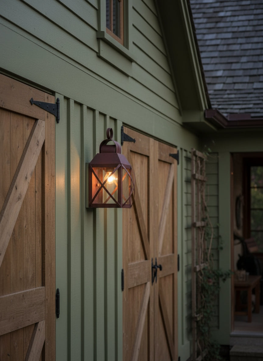 A brown copper wall light fixture with a cylindrical shape and a circular handle on top, mounted on a wall.