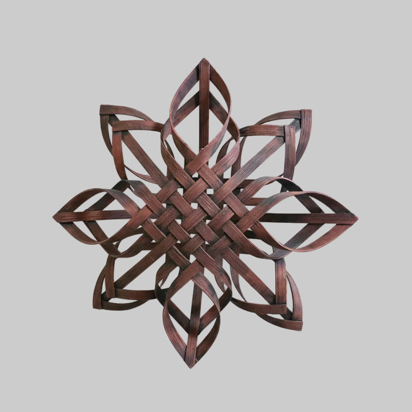 Wooden woven star wall art on a rustic wooden background