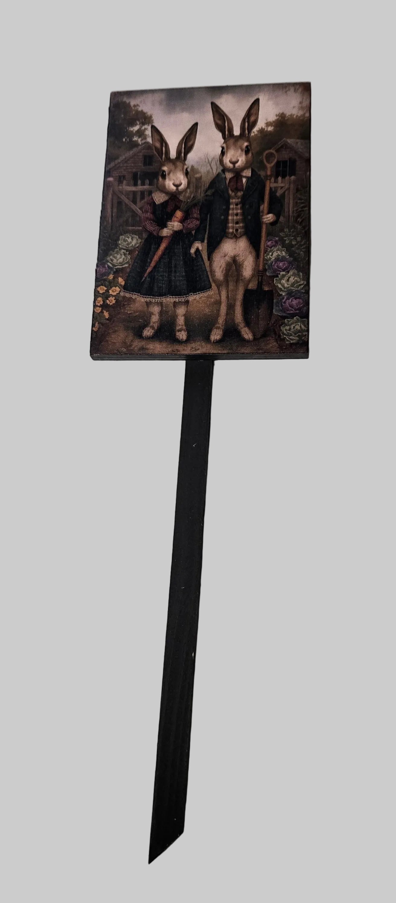 Decorative sign with rabbit-themed design on a stand against a light gray background