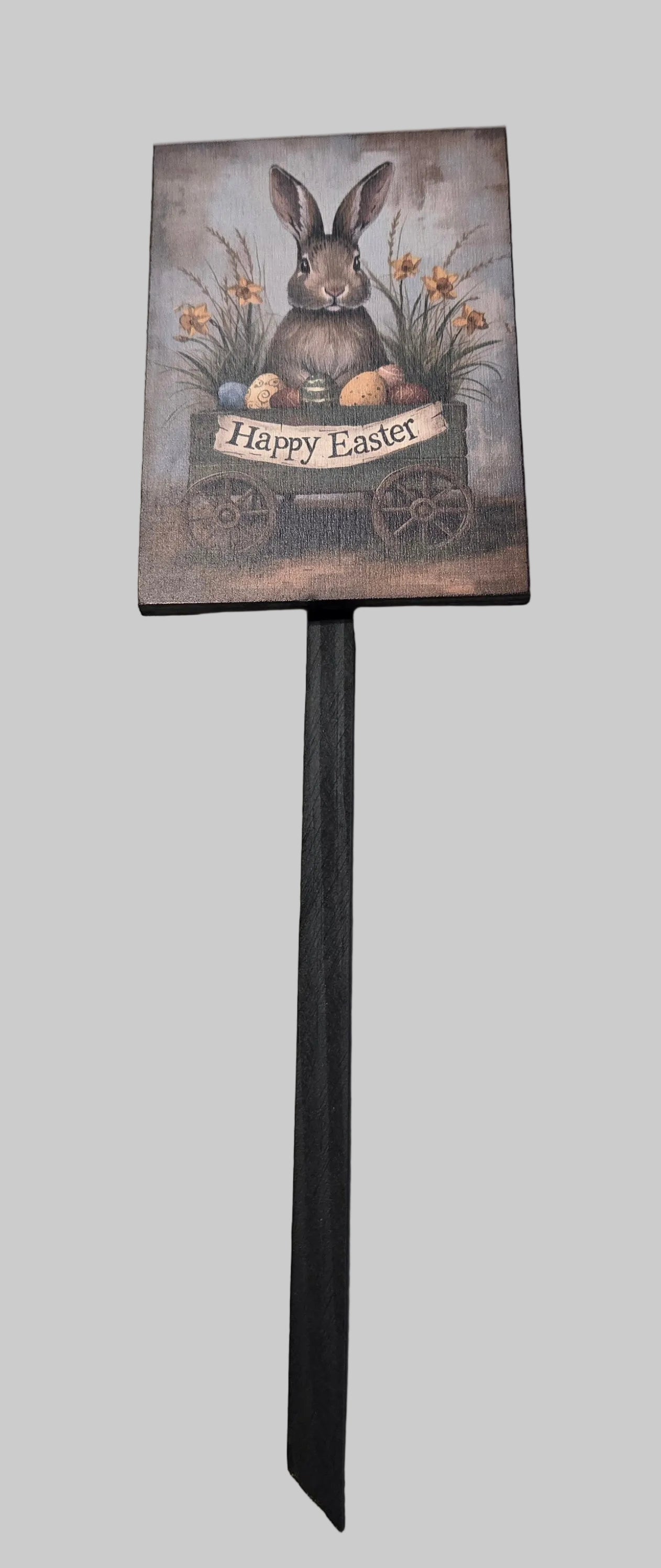 Decorative Easter sign with a rabbit and 'Happy Easter' text on a gray background