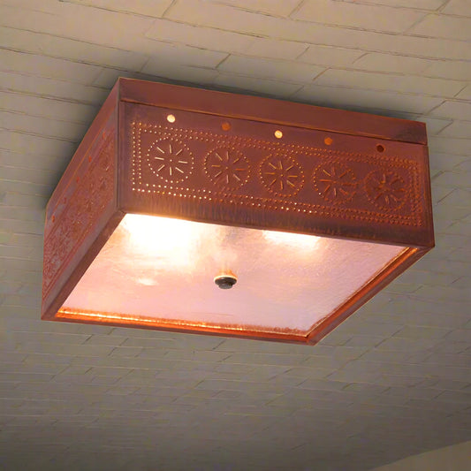 Rustic tin ceiling light fixture with embossed design on a white background