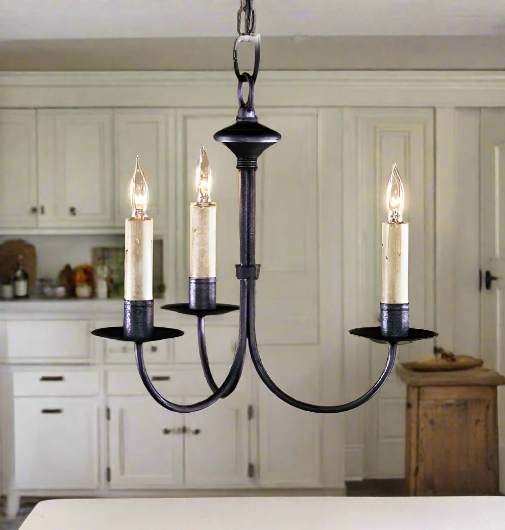 A black wrought iron chandelier with three light fixtures, designed in a classic style.