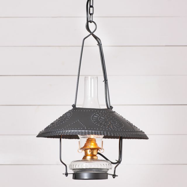 Vintage-style pendant light with dark metal shade and clear glass cover on a white wooden background