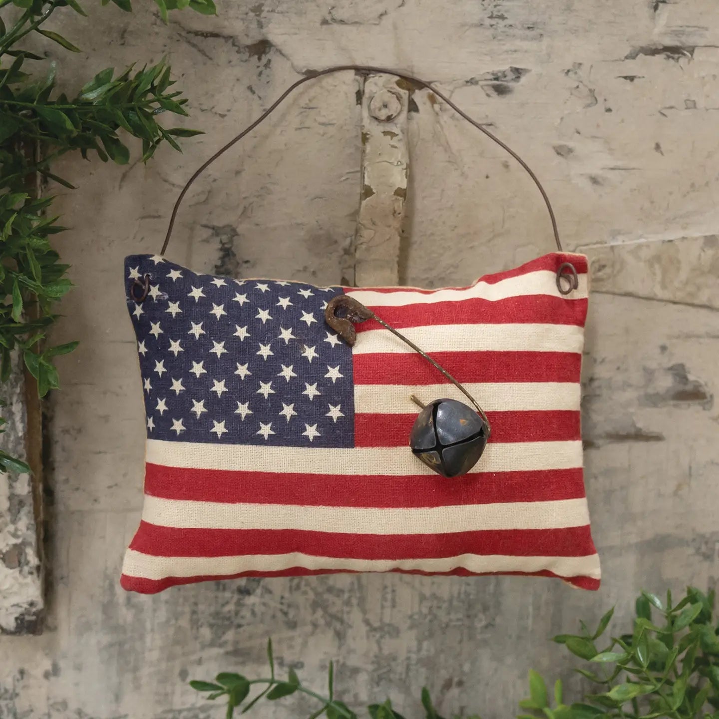 Flag ornament with rusty bell on wooden door