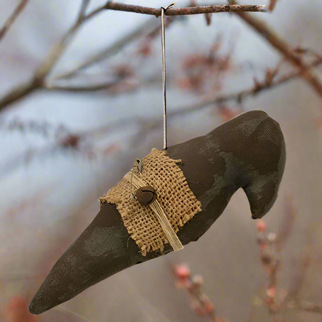 Stuffed black crow with burlap ornament on white background