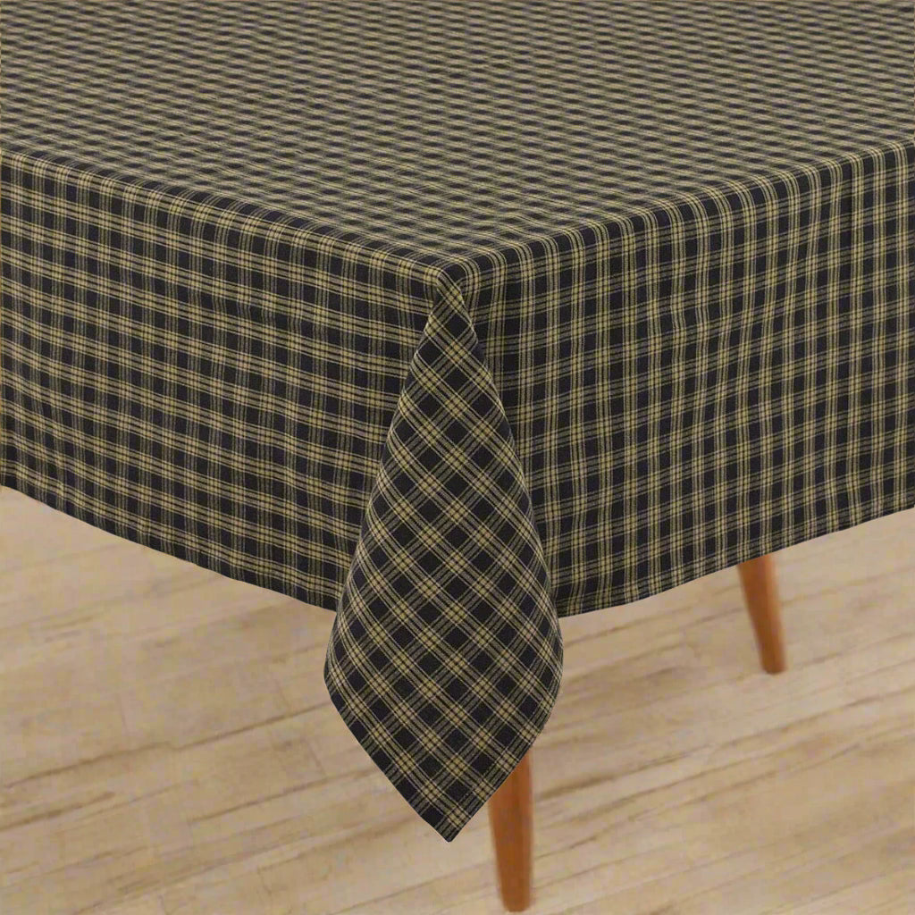 Tablecloth in Sturbridge black pattern displayed on a table