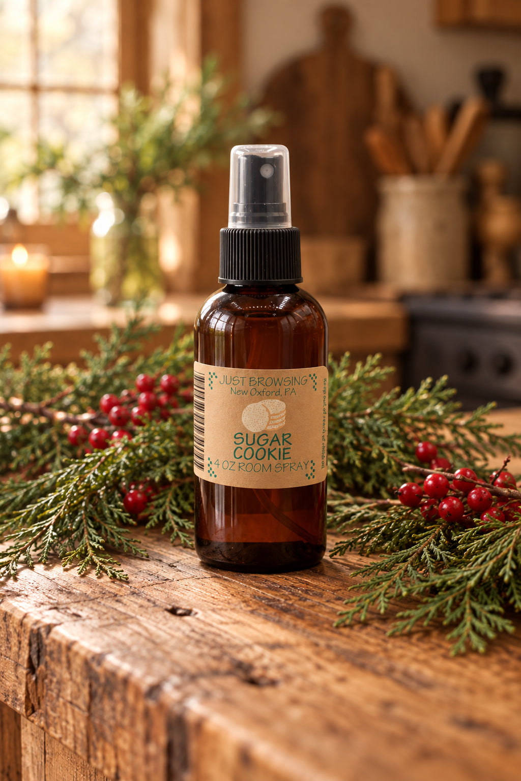 A 4oz bottle of Sugar Cookie room spray with a mist spray top. The bottle is brown with a label that has the product name and an image of a cookie.