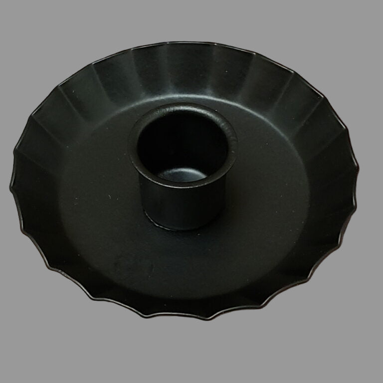 Candle cup with fluted edge resembling a pie crus on a rustic wooden surface