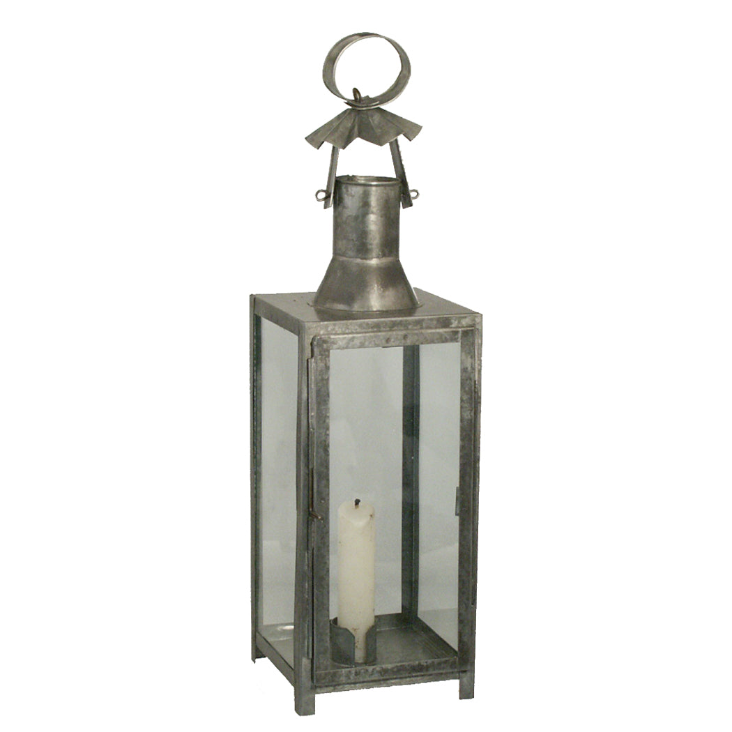A dark gray tin lantern with glass panels, featuring a round handle and four legs.