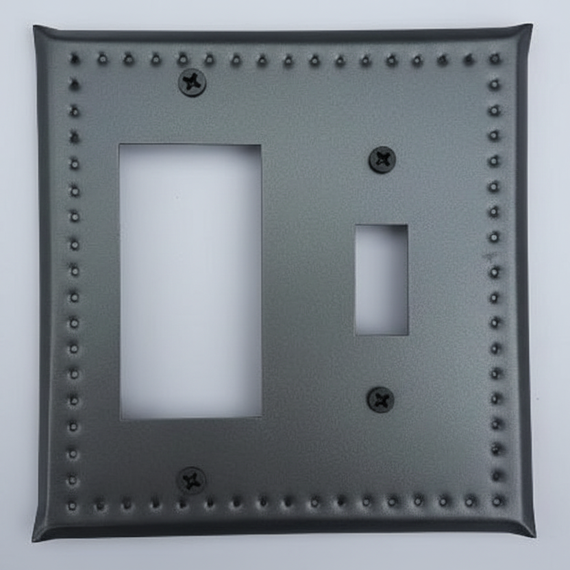 Decorative light switch cover with nailhead trim on a white background