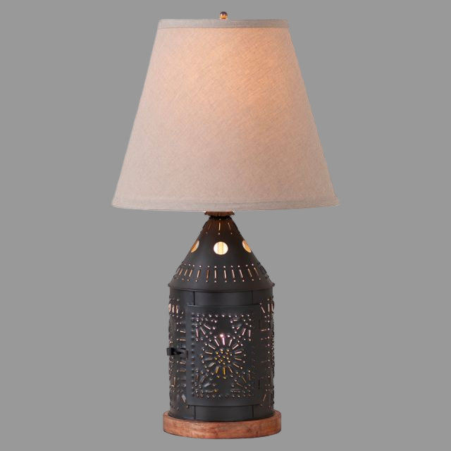 Decorative table lamp with a textured black base and beige lampshade on a white background