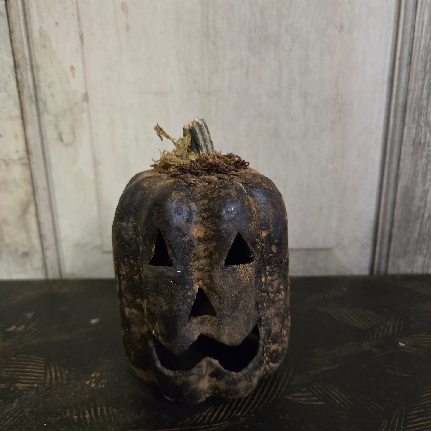 Decorative black metal door knocker on a wooden door