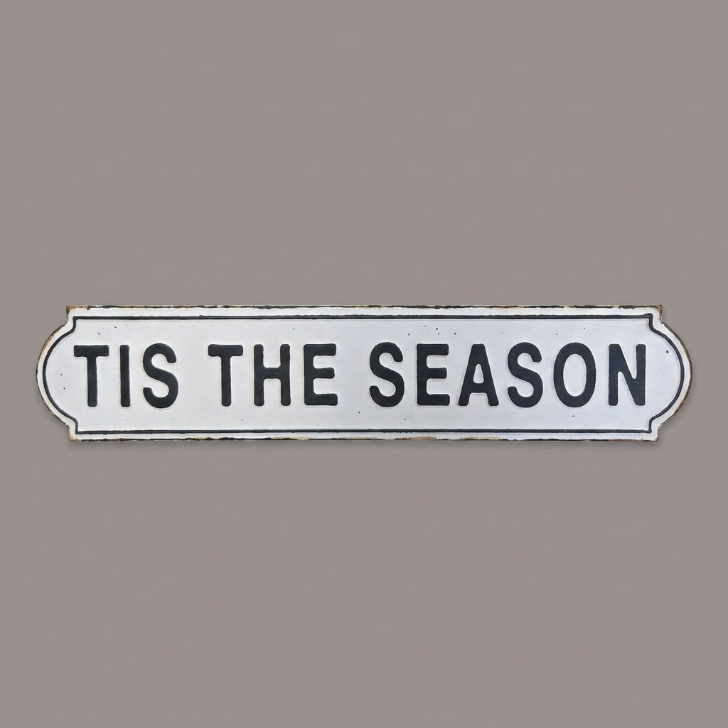Decorative sign with 'TIS THE SEASON' text on a textured surface