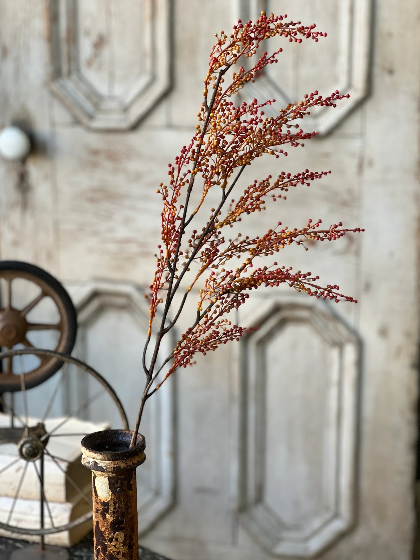 A faux Torchlight berries spray with shades of orange and mustard tones, designed for home decor.