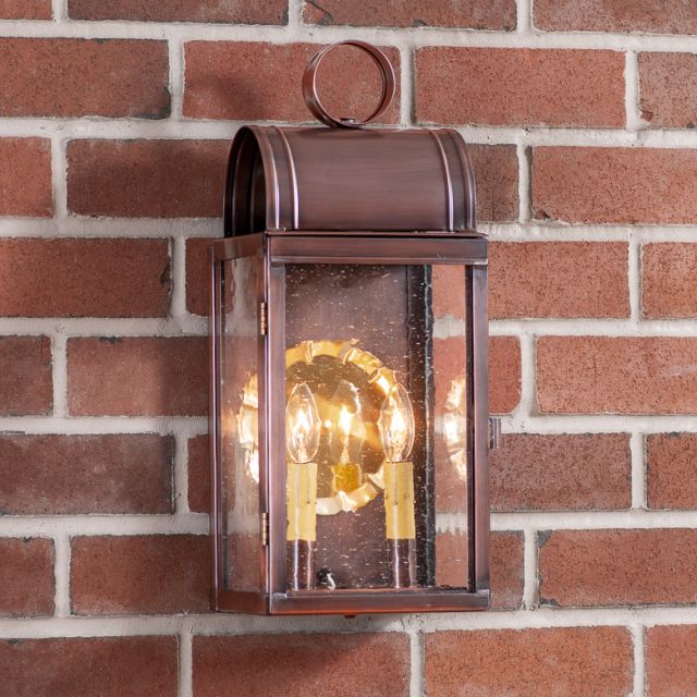 Copper outdoor wall lantern on a brick wall