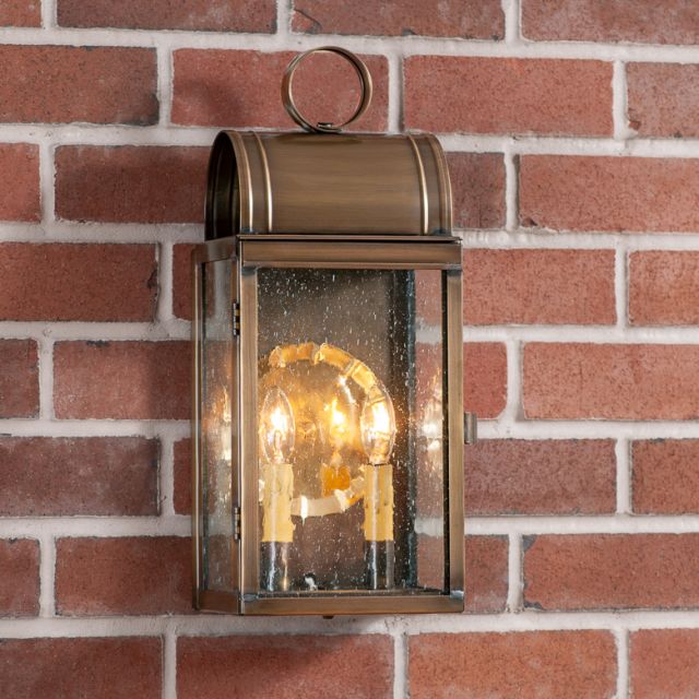 Bronze outdoor wall lantern on a brick wall