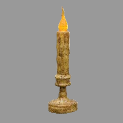 Flickering candle in a decorative holder on a blurred background with greenery beside it