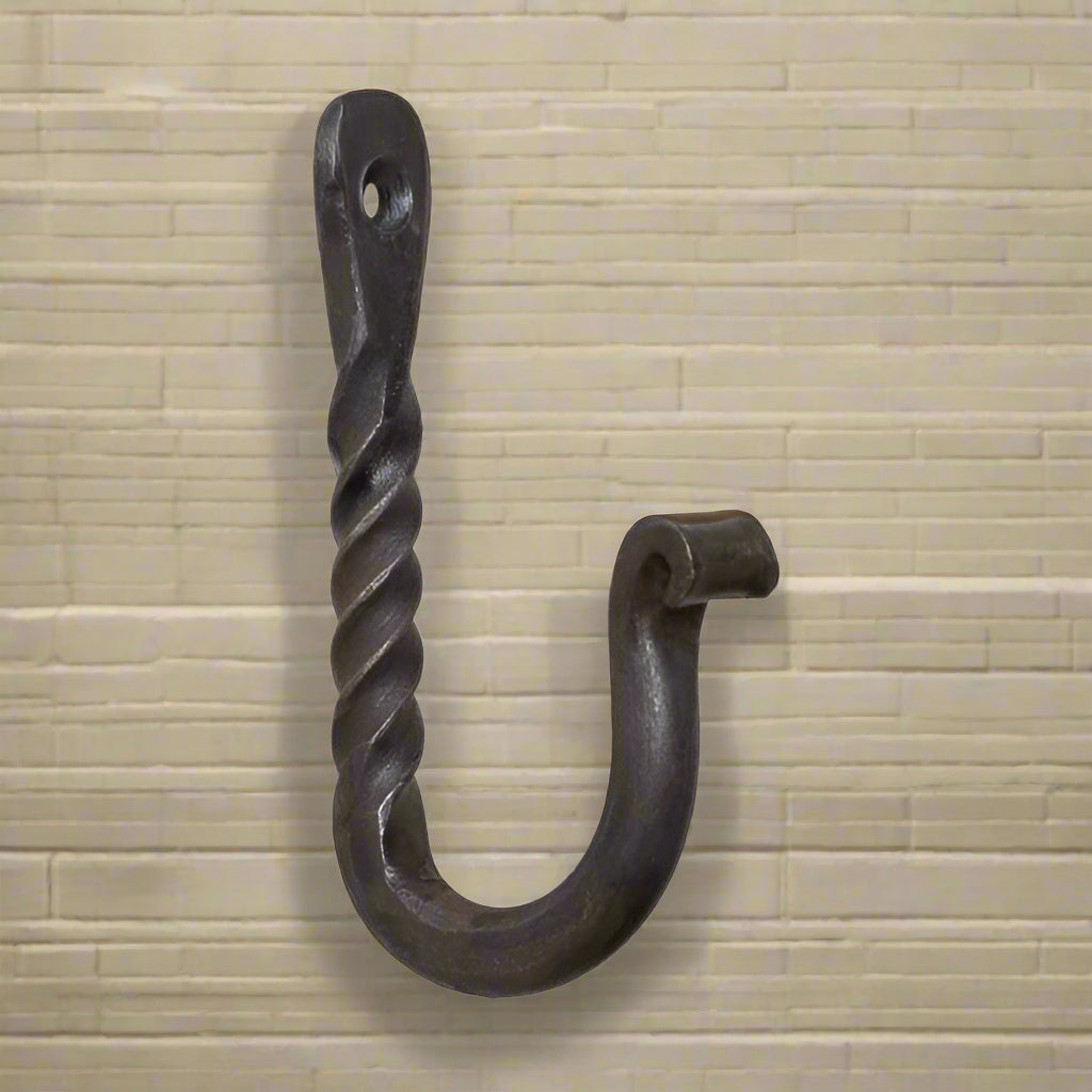 A twisted wrought iron wall hook with a loop at the top for hanging.