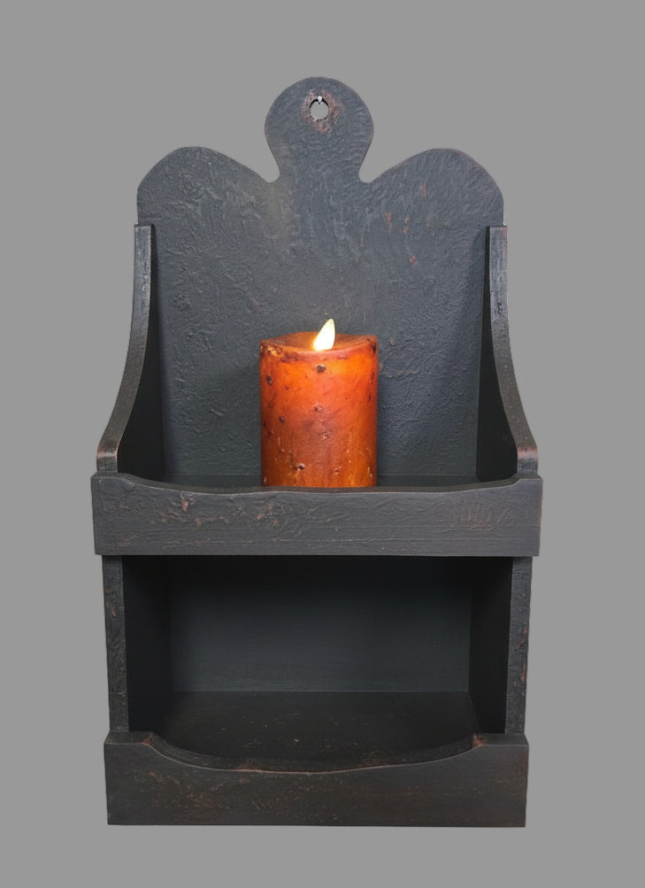 Two shelf cabinet in a rustic black color with a battery operated candle