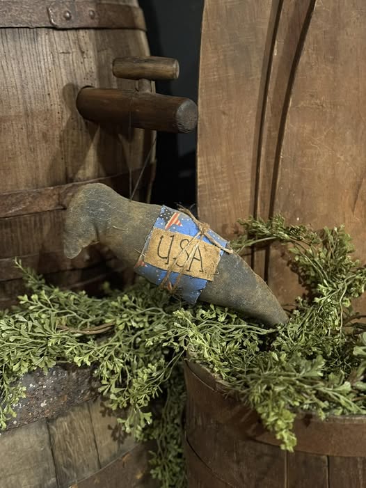 Vintage-style crow ornament with a 'USA' tag on a wooden background