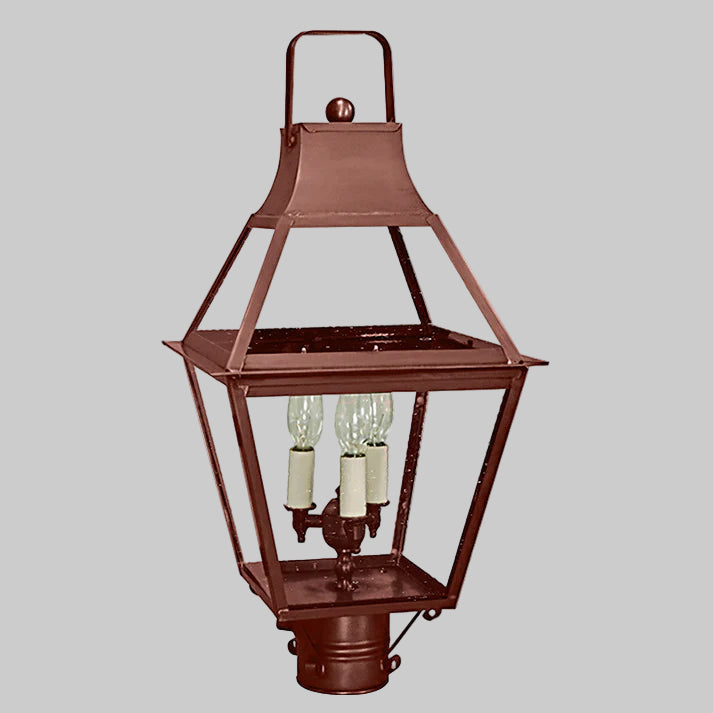 Copper outdoor post lamp with three light bulbs on a gray background