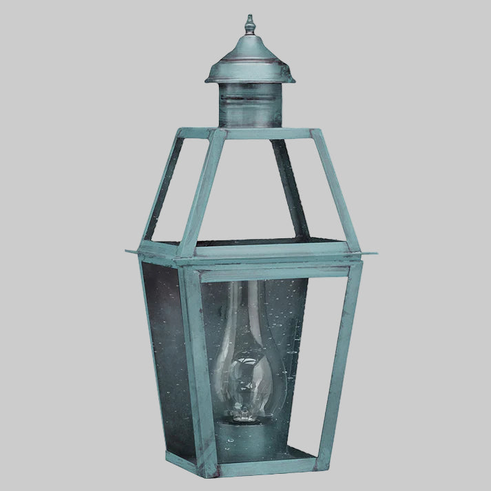Vintage-style lantern with a verdi gris finish on a white background