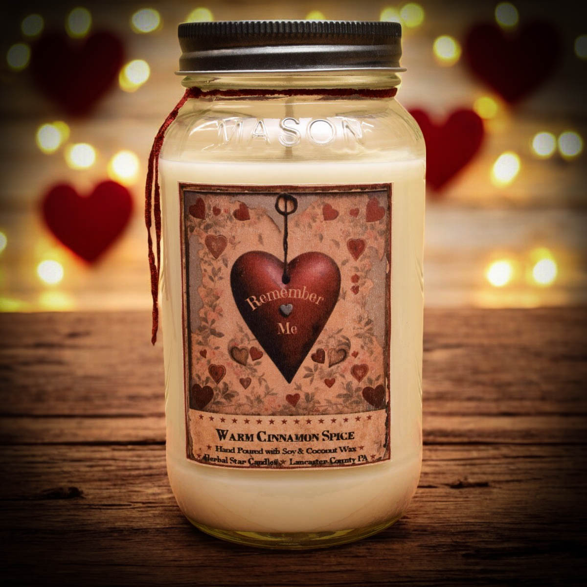 Mason jar candle with cream colored wax and artwork featuring a heart and text
