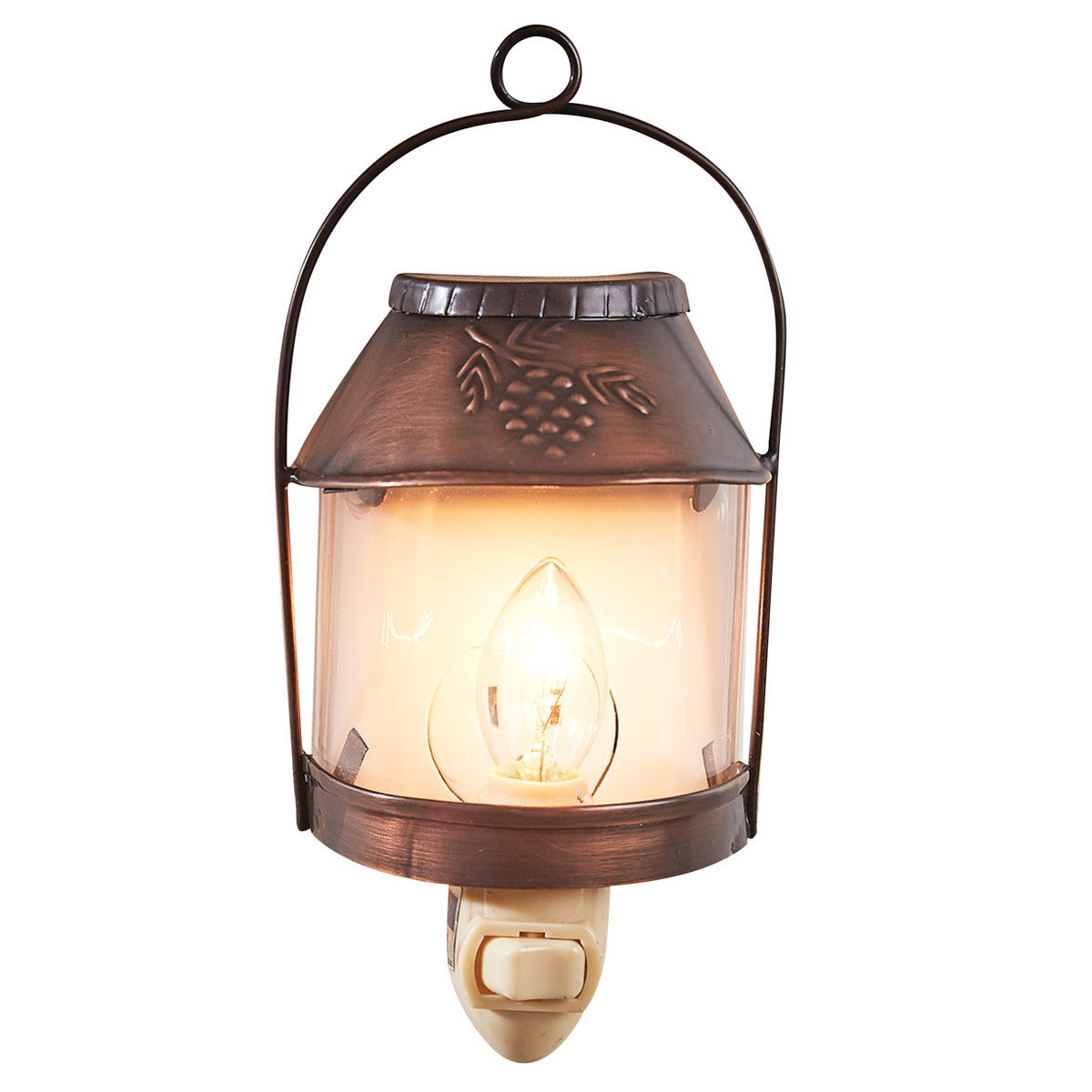 A brown, rustic style Valley Pine Night Light with a pinecone design on the top and a lit lamp inside.