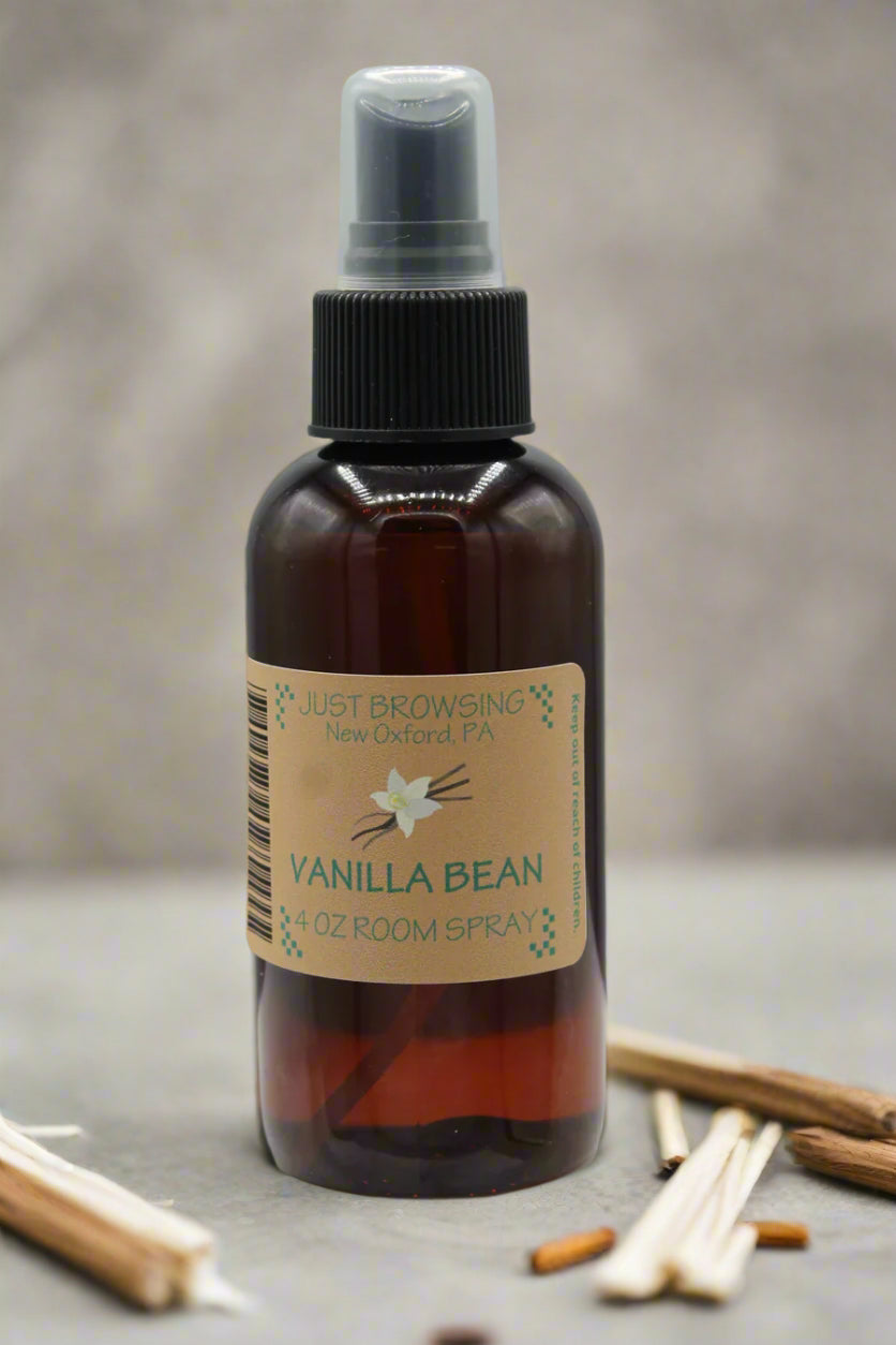 A 4oz bottle of Just Browsing Vanilla Bean room spray with a spray nozzle on top.