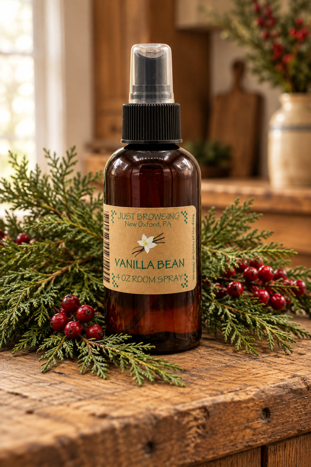 A 4oz bottle of Just Browsing Vanilla Bean room spray with a spray nozzle on top.