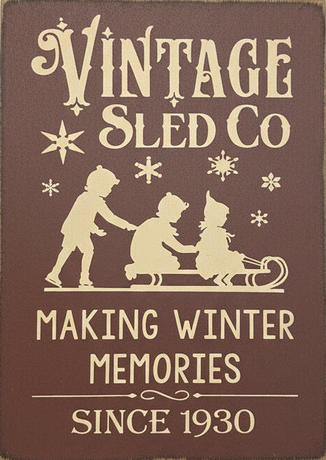 Decorative sign with 'Vintage Sled Co' text and winter-themed graphics on a dark background.