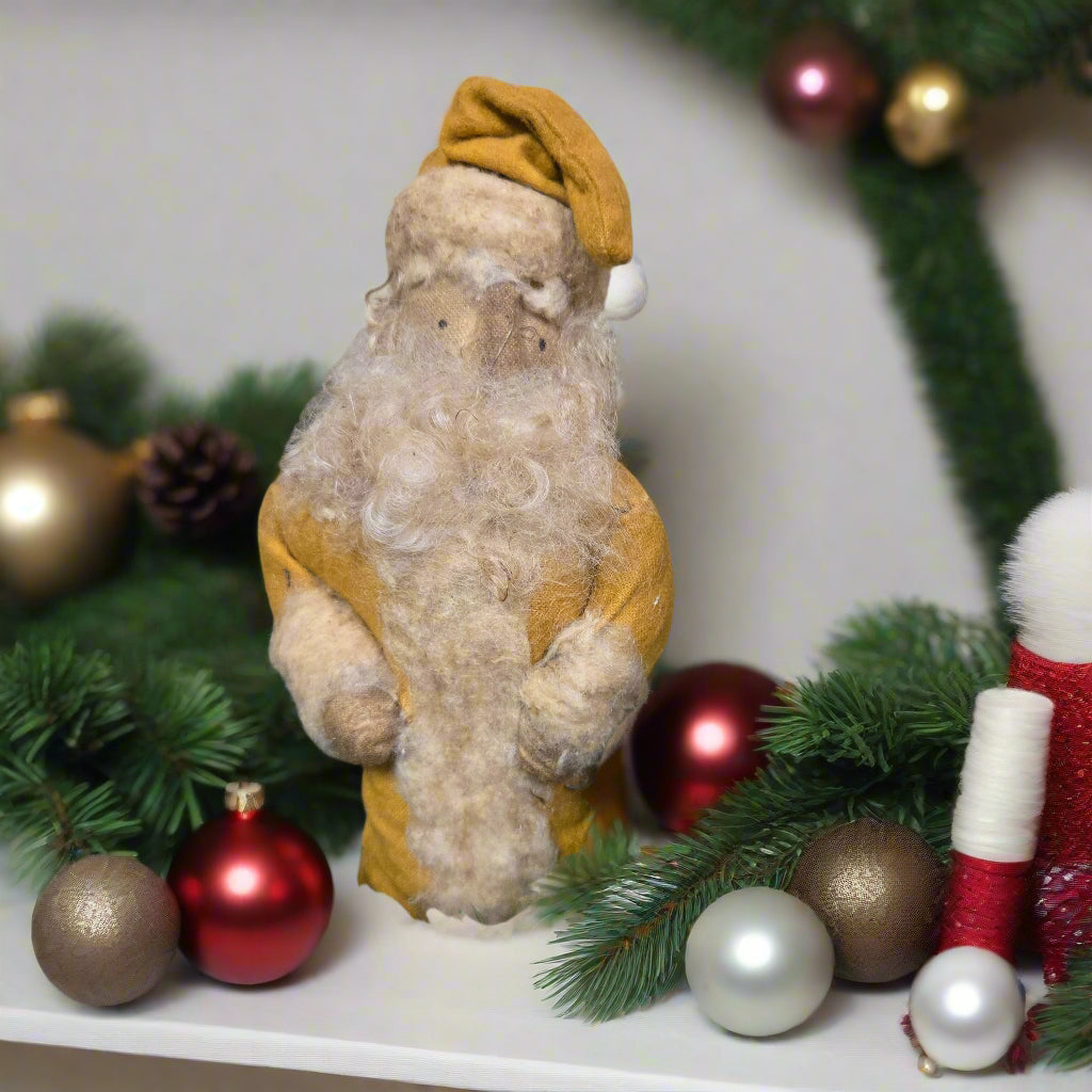 Decorative wreath with a fabric Santa and pinecones on a wooden surface