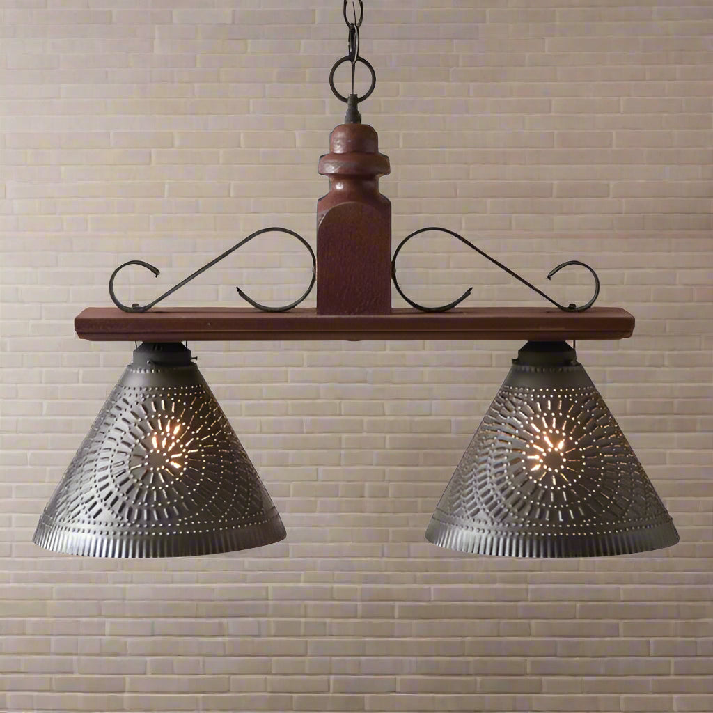Two light pendant light with punched tin shades in plantation red finish.
