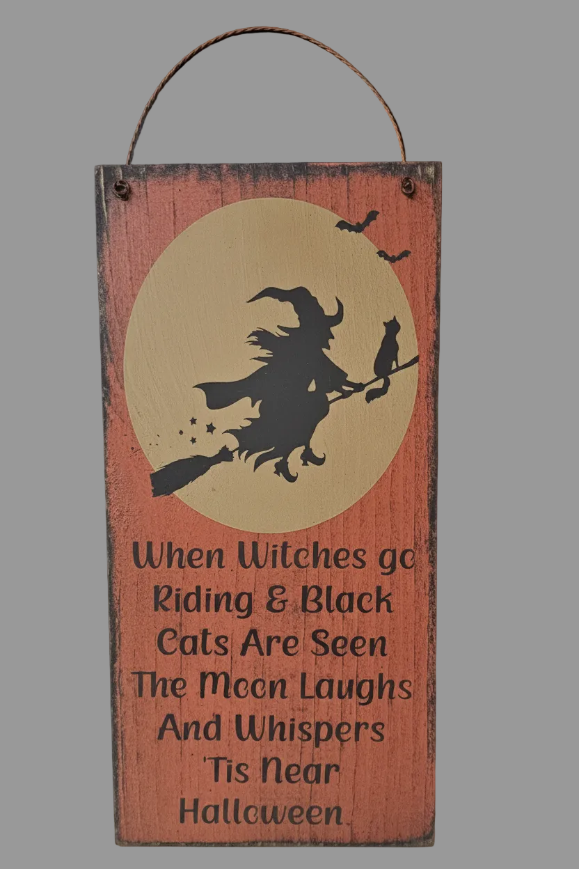 Wooden Halloween sign with witch silhouette and text on a red background