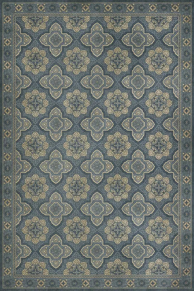 A Colonial reproduction floor cloth featuring a geometric pattern in a blue color.