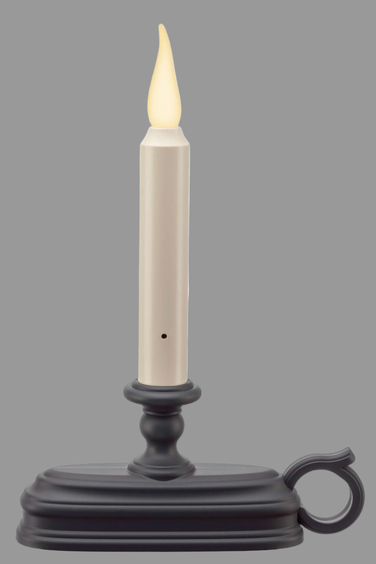 A battery-operated window candle with a warm white flame and a 3D effect, placed on a black holder with a patented flame design.