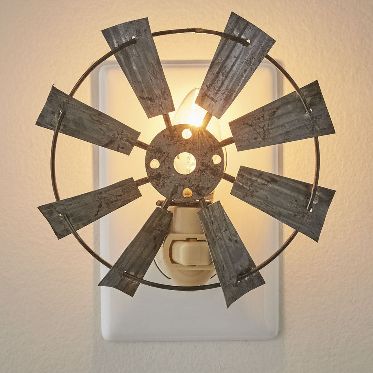A night light that resembles a windmill plugged into a wall outlet