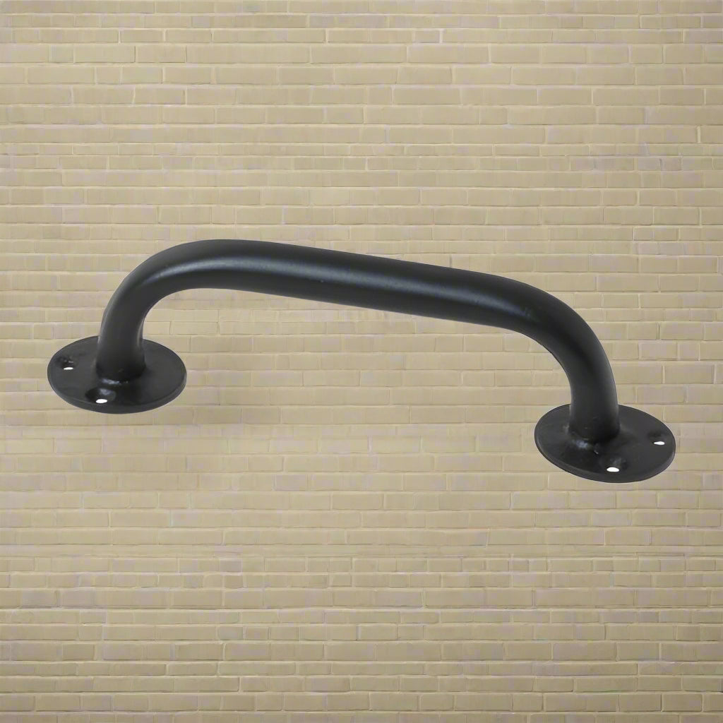 A wrought iron cabinet pull handle with a matte black finish, featuring a traditional, rustic design.
