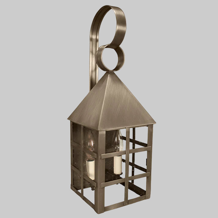 Bronze outdoor wall lantern with a decorative ring on a gray background