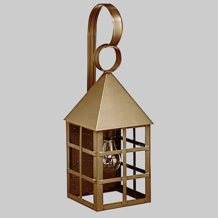Gold-colored lantern with a light bulb inside on a gray background