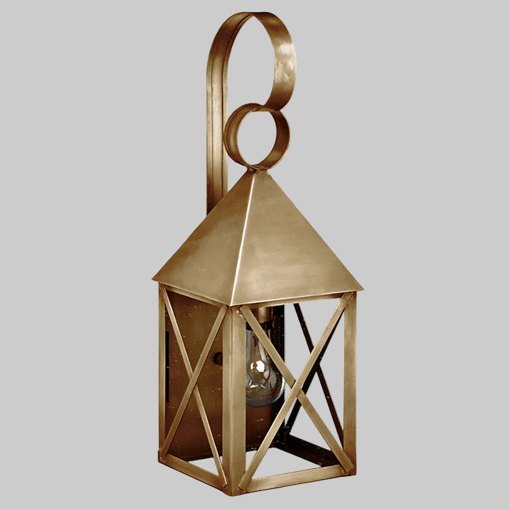 Decorative brass lantern with geometric design on a gray background