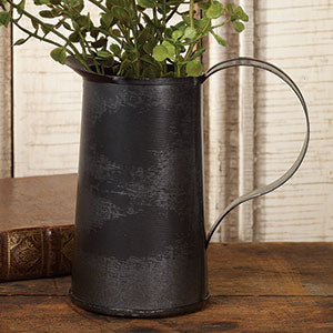 Primitive tin pitcher with artificial greenery