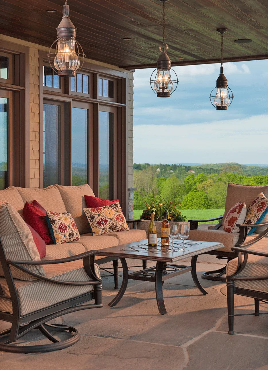 Open air porch with three colonial outdoor lights over a patio set