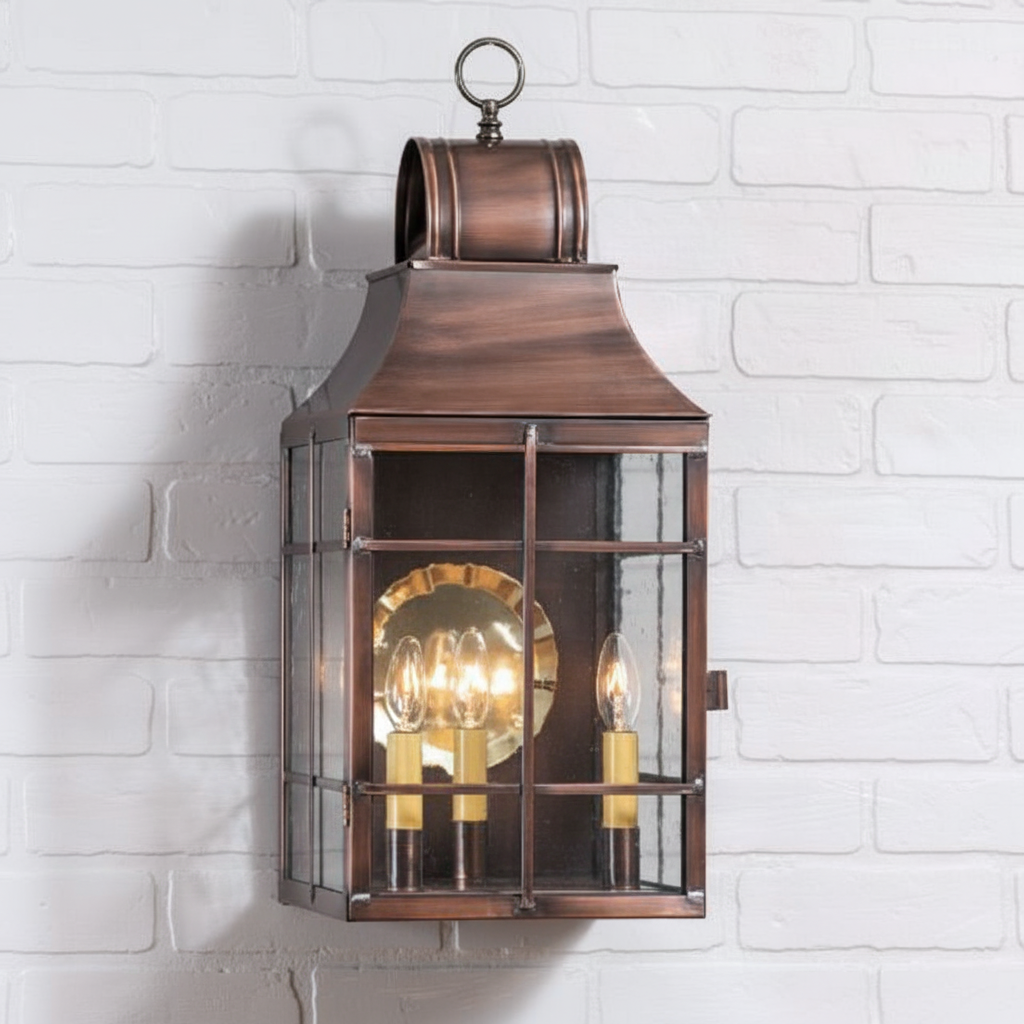 Bronze lantern with glass panels on a white brick wall