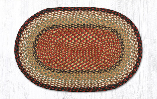 An oval braided jute rug with concentric bands of rust red, beige, brown, and black, shown flat against a white wood-textured background.