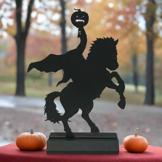 Black silhouette of a person riding a horse with a menacing face on a white background