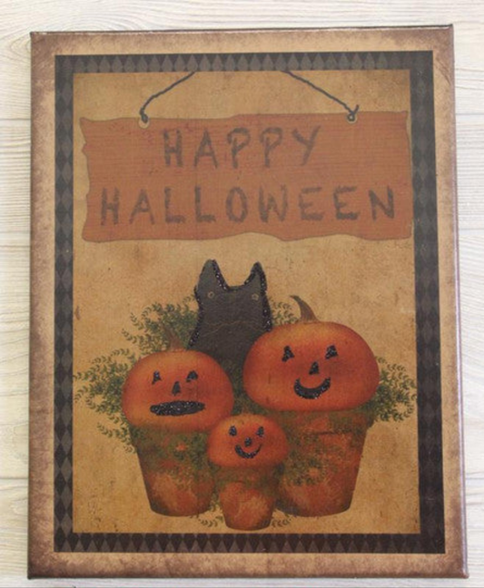 Canvas print the words "Happy Halloween" over a group of three potted pumpkins and a black cat
